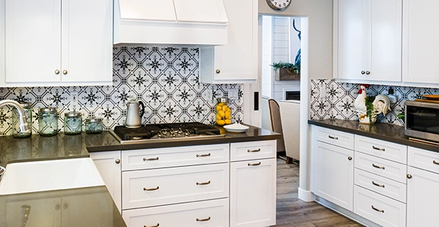 A picture of freshly refinished white kitchen cabinets.