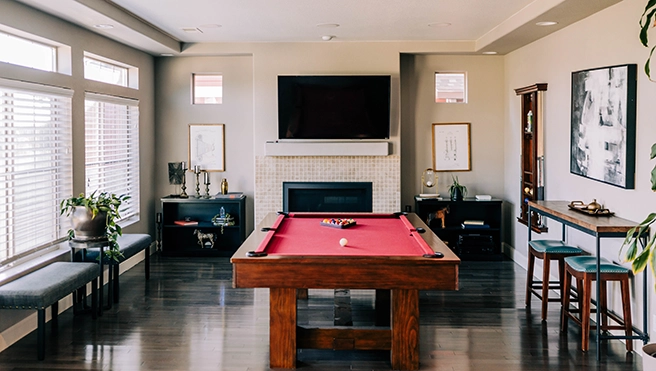 A picture of a game room with popcorn ceiling.