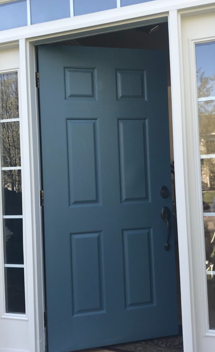 Medium blue paneled front door white side and top windows
