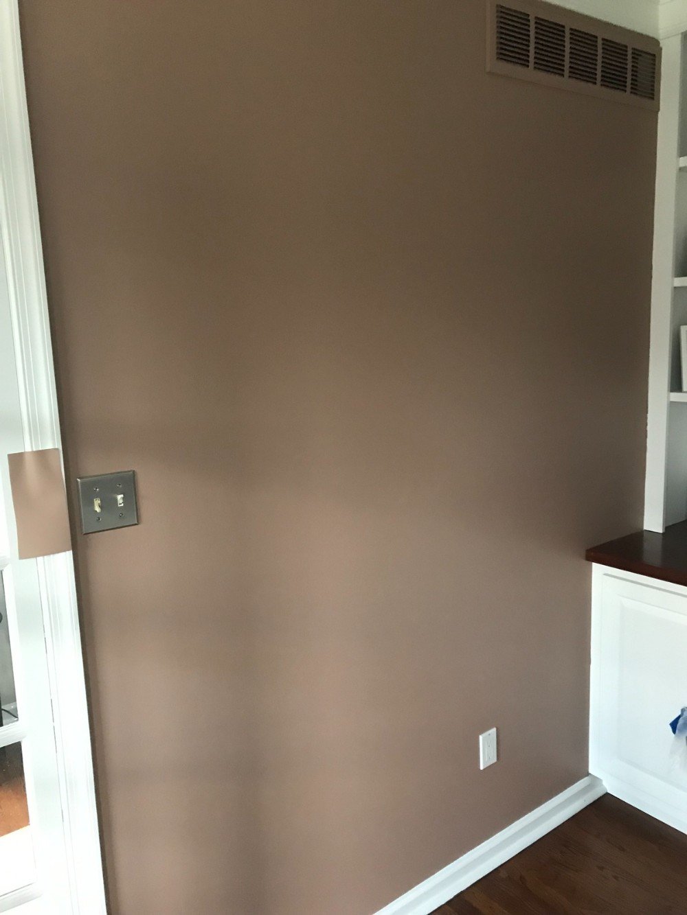 closeup of painted office walls some white trim hardwood floors