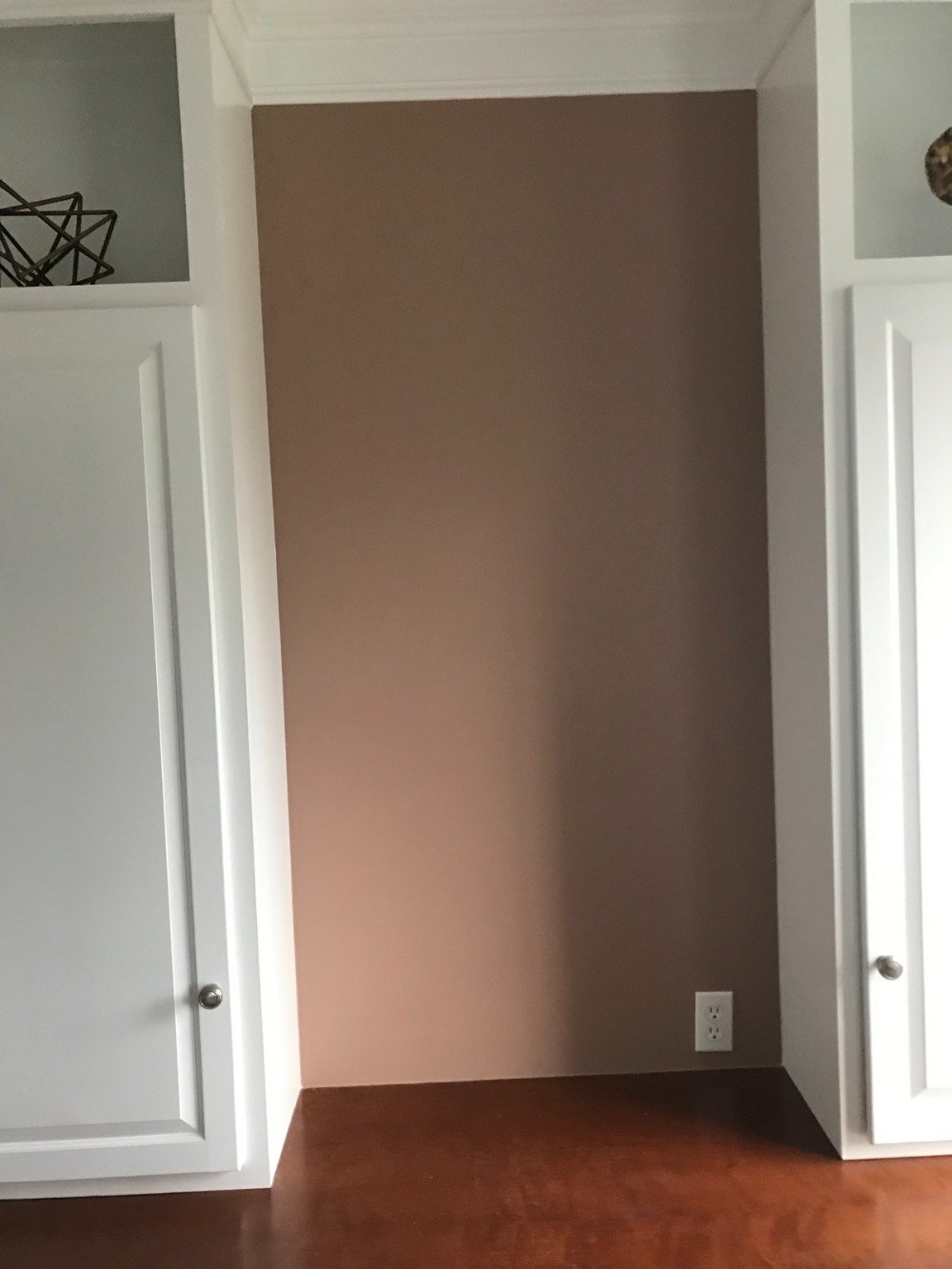 Home office walls painted light red white trim and shelving