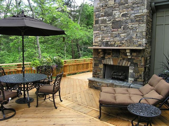Patio with table set and fireplace