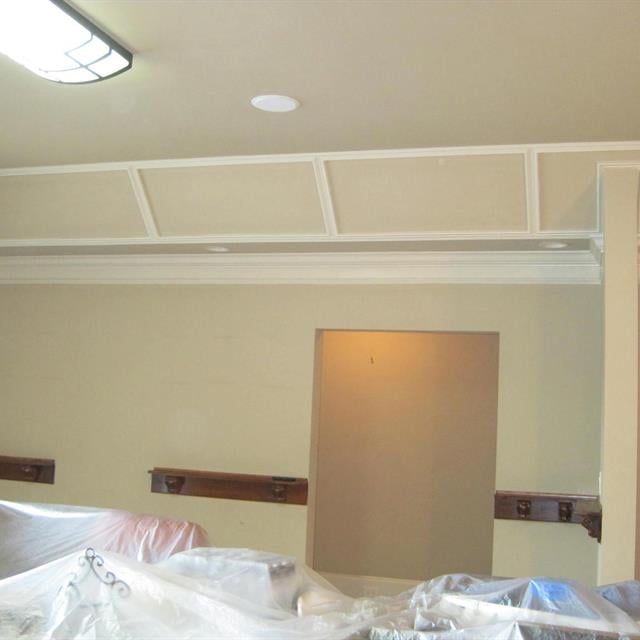 Room with furniture covered in plastic