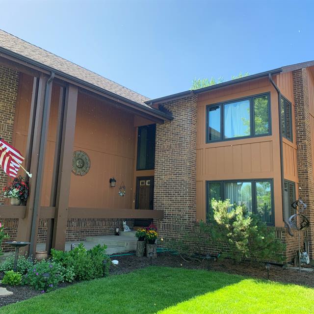 brown home with grass lawn 