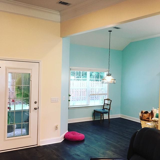 cream and teal room with hardwood flooring