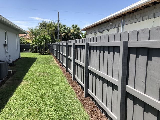 grey fence next house