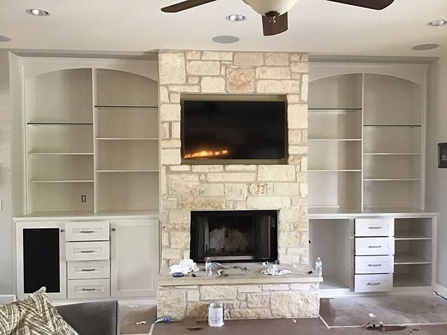 white cabinets with stone fireplace
