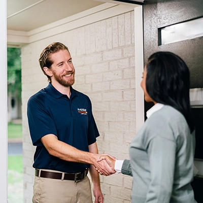 Painting professional shaking hands with female customer.