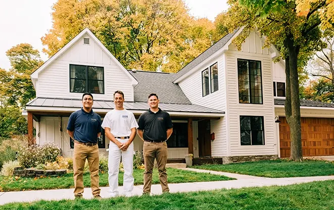 Row of smiling Five Star Painting associates standing outdoors.