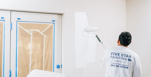 Five Star Painting professional painting the inside of a commercial building.