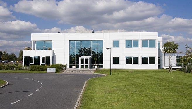 Industrial building with mowed grass lawn.