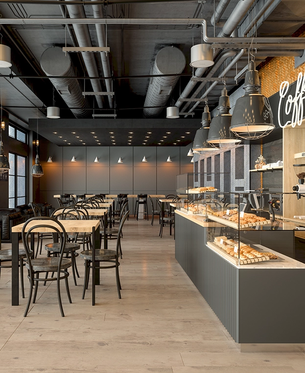 Modern coffee shop with gray walls and exposed ceiling ductwork.