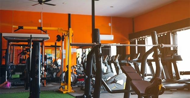 Fitness room with orange painted walls.
