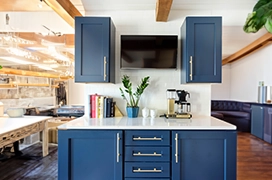 A modern kitchen with blue cabinets.
