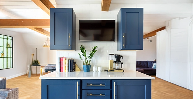 Large kitchen with wood floors, blue cabinets.