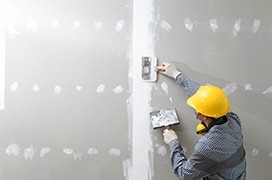 Five Star Painting professional repairing drywall.