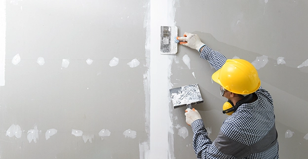 Five Star Painting professional repairing drywall.
