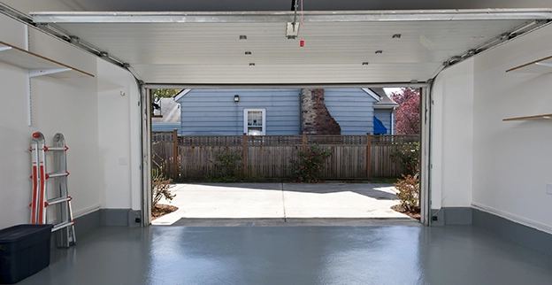 Two-car garage with a freshly painted floor and an open door.