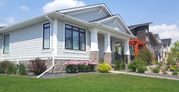 Exterior of a craftsman style home on a sunny day.