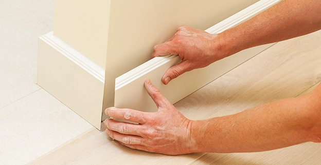 Close-up of baseboard installation.