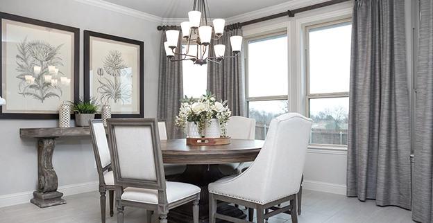 Formal dining room with neutral colored furniture and walls.