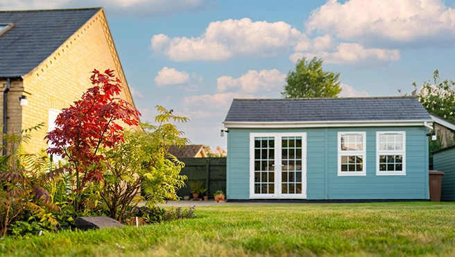 Teal shed in a backyard.