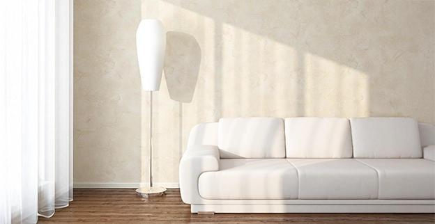 Photo of a cream colored wall with textured paint.