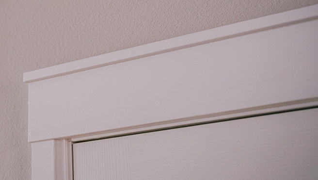 Trim on the top of an interior door.