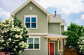 Exterior of a home with green vinyl siding.