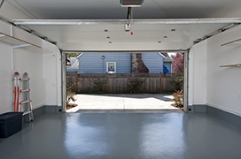 Garage with floor coating and an open door.