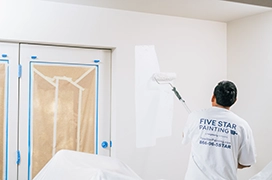 Five Star Painting professional painting a wall.