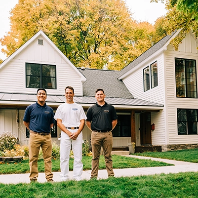 3 Five Star Painting associates standing outside a house.