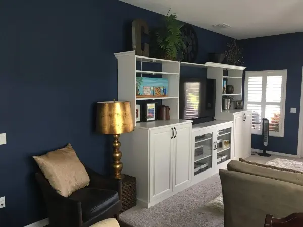 Living room with dark blue walls painted by Five Star Painting.
