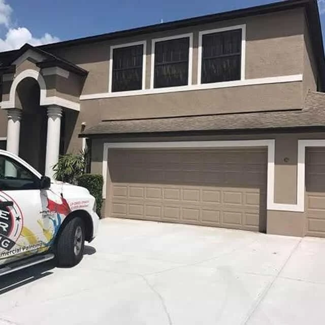 Brown and white home after exterior painting from Five Star Painting.
