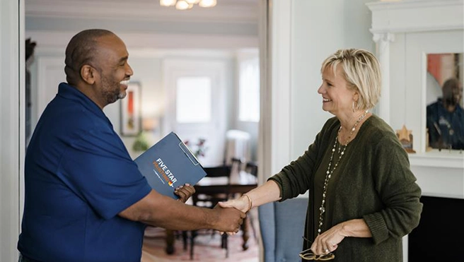 Five Star Painting professional shaking hands with a customer.