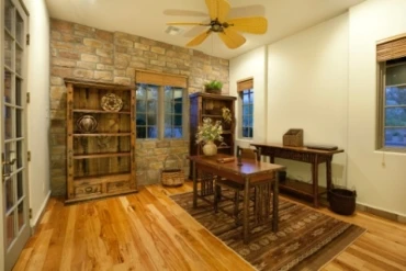 Photo of a warm study with wooden furniture and a wooden floor.