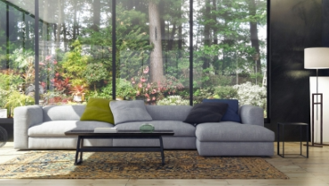 Photo of a living room with a large window looking out onto a copse of trees