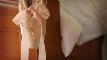 image of ballerina shoe hanging on bed
