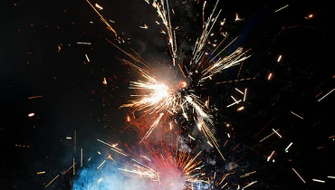 Photo of a firework exploding in red, white, and blue sparks.