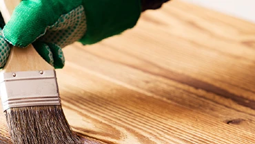 Person painting wood