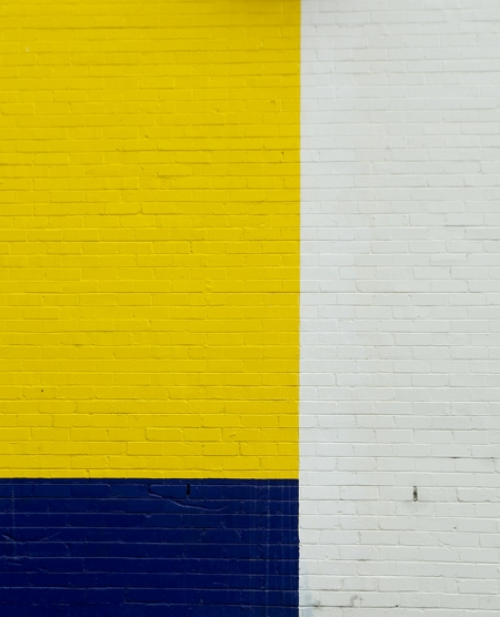 Yellow, blue, and white brick wall.