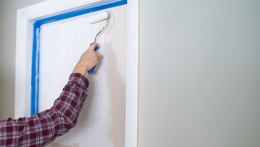 Person painting bedroom door
