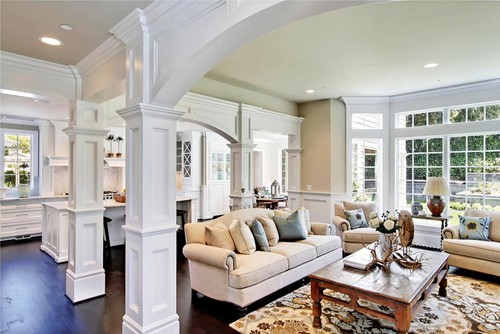 House with white walls, a dining room, a bar, and a wooden front door.