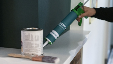 Person using paintable caulk