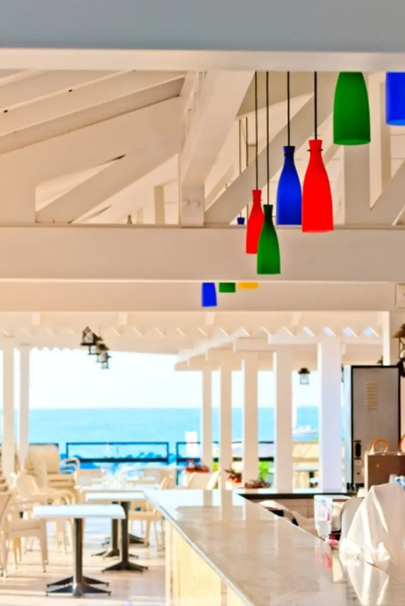 White Beachfront Restaurant with Multi-colored Hanging Lights.  