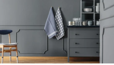 Photo of darkly colored kitchen.