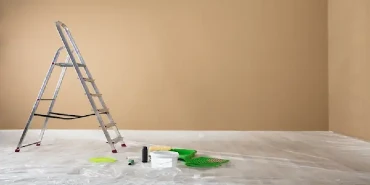 Stepladder with painting supplies on the floor